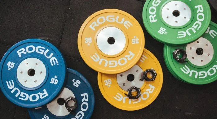 Weight plates stacked and loaded on a barbell