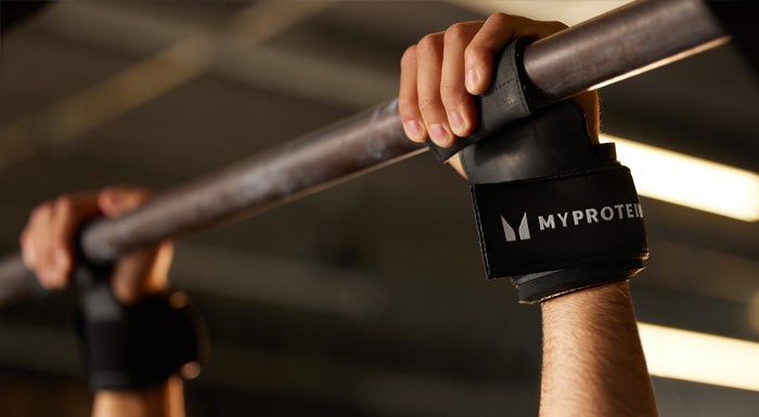 A Myprotein athletes using grip handles to perform a pull-up.