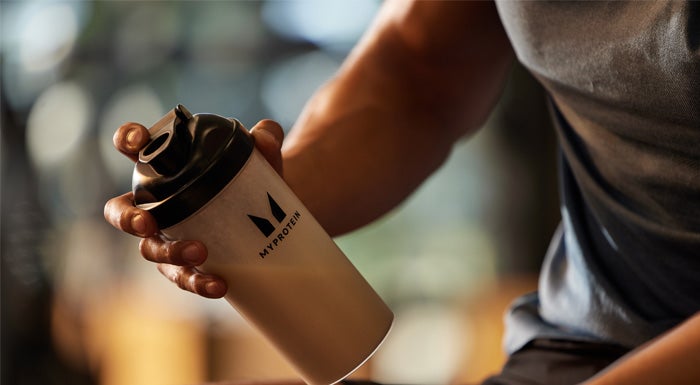 A Myprotein athlete shaking a protein shake with creatine.